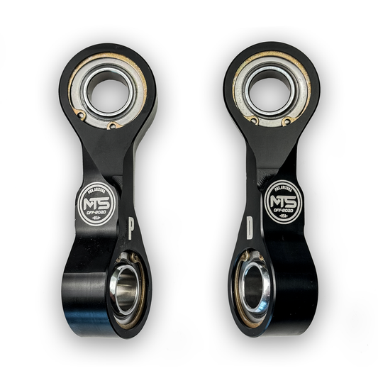 Two black metal connecting rods with bearings on a white background