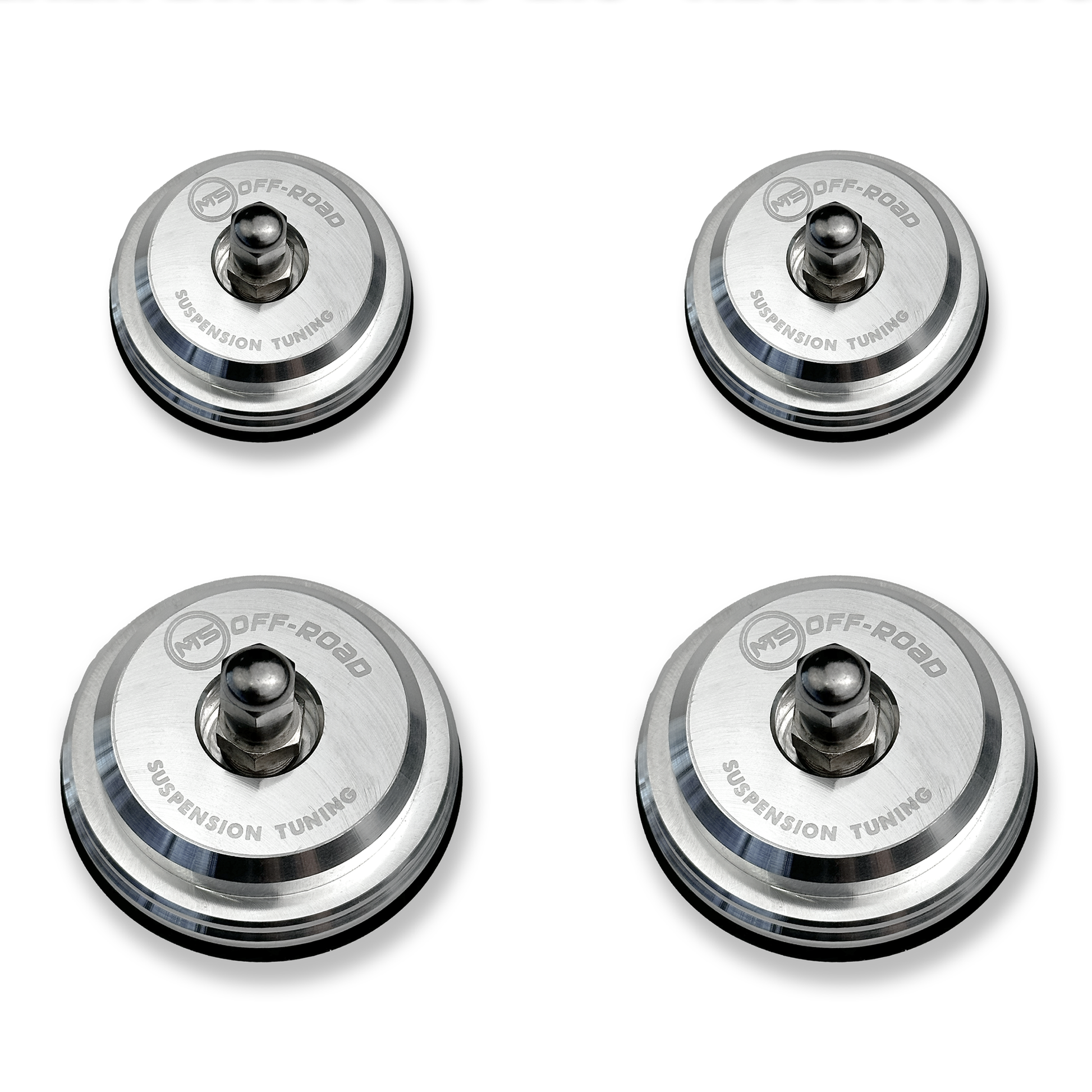 Four metallic suspension tuning components on a white background