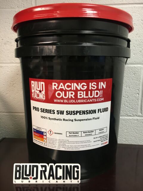 5 gallon pale of Blud Racing 5W suspension fluid with a red lid and a label that includes the brand name and product type.